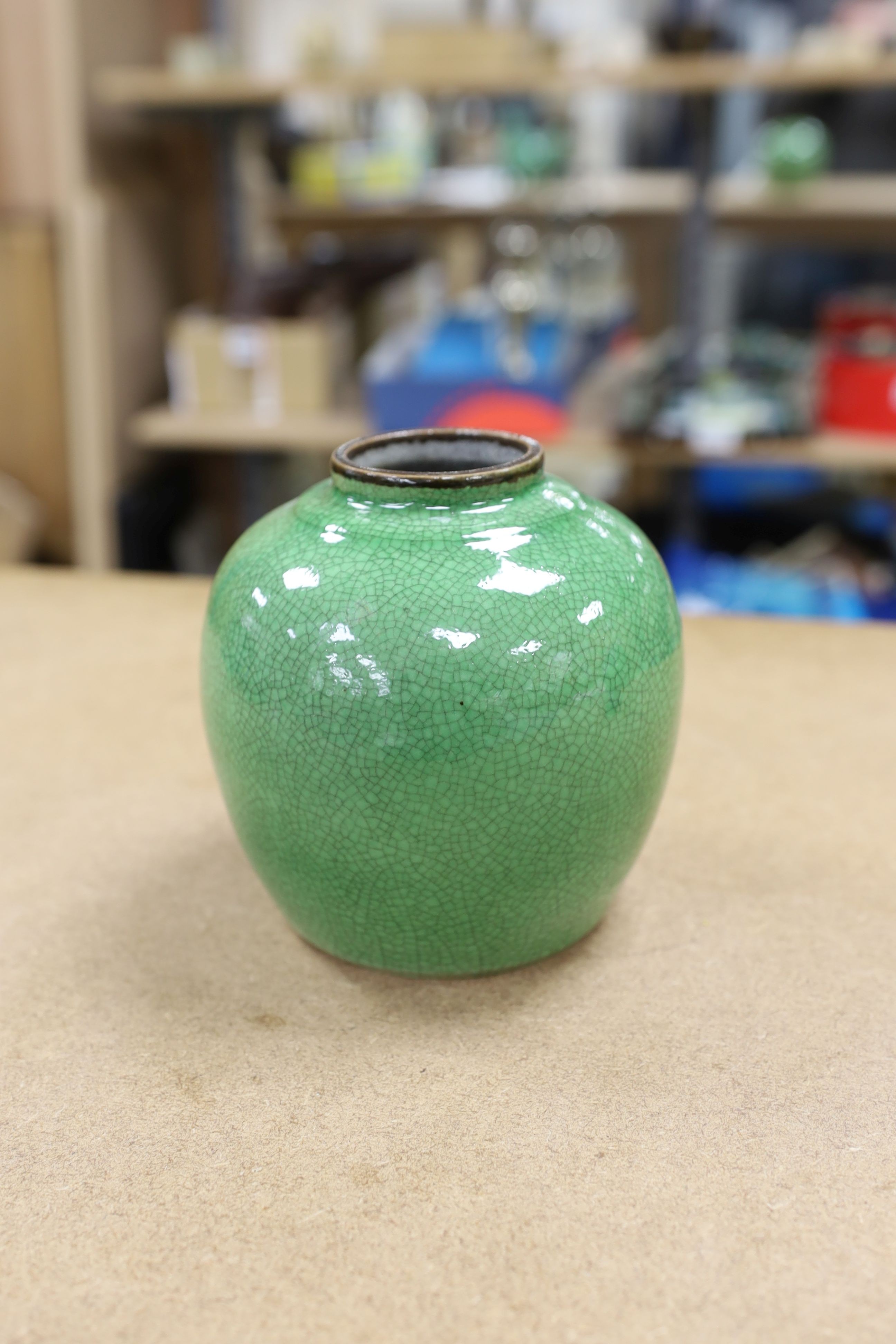 A 19th century Chinese green glazed model of a lion-dog, and two green crackle glaze jars, tallest 16cm